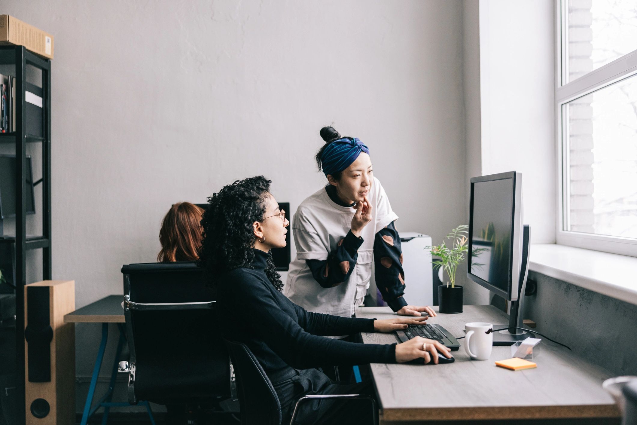 Support professional assisting a colleague in an office